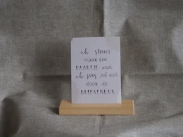 Greeting card with handwritten Dutch text about a friend and a journey.