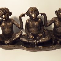 Hear-see-shut up monkeys in leaf