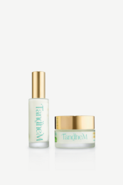 Luxurious face treatment duo with gold-trimmed white bottles and jars, skincare set with elegant packaging.