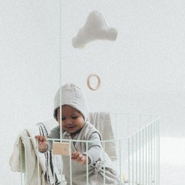 Dark green baby hat with buttons, suitable for infants 0-6 months.