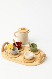  Wooden tea set with teapot, cups, and saucers in natural colors. Includes round, oval, and rectangular shapes. Suitable for imaginative play.
