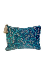  A blue and green floral patterned toiletry bag with a beige zipper pull.