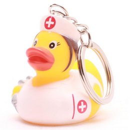 Cute yellow rubber duck with a nurse's hat and red cross symbol, perfect for bath time or as a keychain.