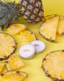  Pineapple-scented soy candle with a tropical Pina Colada fragrance, featuring a round, tall shape.