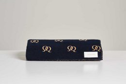 Soft, cozy blanket in navy blue with gold circular patterns, perfect for adding warmth and style to any room.