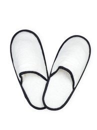 Pair of white and black slippers with a simple, minimalist design. The slippers have a soft, plush material and a comfortable, slip-on style.