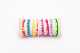  16 colorful woven bracelets on a roll, suitable for casual or festival wear.