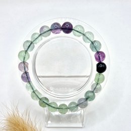  Fluorite beaded bracelet with 8mm round beads in various shades of green, purple, and black.