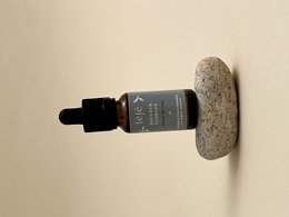 Floral, soft, linen-scented perfume in a glass bottle with a dropper.