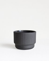 Dark gray ceramic mug with ribbed texture, suitable for serving cappuccino or other hot beverages.
