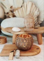 Rustic, boho-style candle holder made of natural materials with intricate carved patterns. Suitable for use with tealight or votive candles.