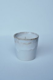  White ceramic candle and cup set with a minimalist design.