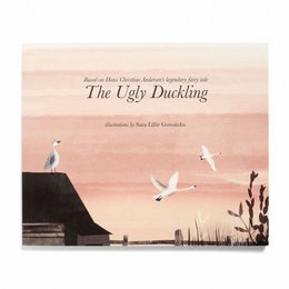 A classic children's book, "The Ugly Duckling" by Hans Christian Andersen, featuring a hardcover book in multiple languages including English, Danish, German, and Chinese Simplified. The cover illustration depicts a serene landscape with a swan and other birds in flight against a warm, sunset-colored sky.