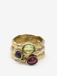 Set of three gold-plated rings with various gemstones including peridot and amethyst. The rings have a hammered, textured finish for a unique, artisanal look.