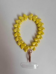  A colorful phone cord bracelet with heart-shaped beads in various pastel shades, including yellow, light pink, and lavender.