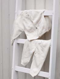 Soft, cozy, and warm knitted teddy bear set in off-white color, perfect for keeping a baby snug and comfortable.