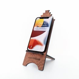 Wooden phone holder with Amsterdam house design, available in 3 variants, suitable for holding smartphones securely.