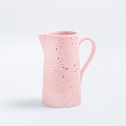 A pink speckled ceramic pitcher and matching cups, perfect for serving drinks at parties or gatherings. The pitcher has a 1.5L capacity and a comfortable handle for easy pouring.