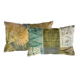 Decorative throw pillow with nature-inspired patterns including a large sunflower, leaf and floral designs in shades of green, gold, and blue.
