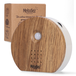 A wooden birdhouse with built-in sound sensor that plays natural bird, ocean, and jungle sounds. Available in various wood tones and finishes.