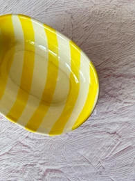  Set of 4 handmade ceramic bowls with yellow and white striped pattern, measuring 7x5x2 inches.