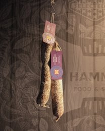 Dark red cured salami, artisanal Italian aged pork salume, sliced rounds, rustic presentation