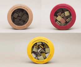 A variety pack of licorice candies in round containers with a vintage-style label that reads "Hattesen Konfektfabrik".