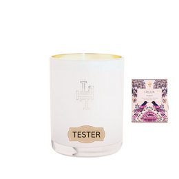 A tall, round white candle with a pink base and a gold-colored lid. The candle has the word "tester" printed on it in a stylized font.