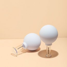  White facial contouring massage cups for skin care, made of soft silicone material, designed to help sculpt and define facial features.