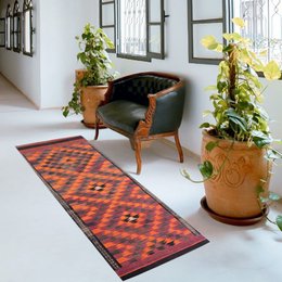 Vintage Merlin Woolen Rug, a vibrant and patterned runner rug with a traditional Southwestern-inspired design featuring diamond shapes in shades of orange, red, and black.