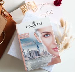 Purifying and brightening face mask with a soft, pink color and a textured surface.