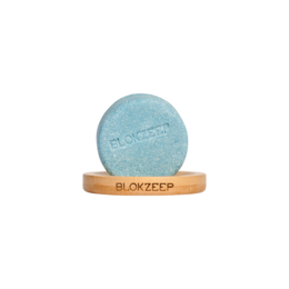 Small round bamboo soap holder with blue soap.