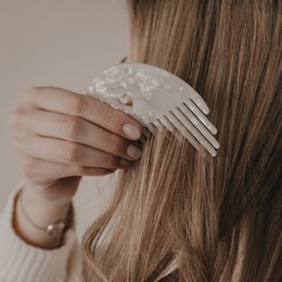  A set of 10 pearl-embellished hair combs in a heart shape, suitable for styling and accessorizing long, wavy hair.
