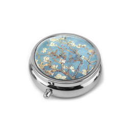 Decorative pillbox with Van Gogh's Almond Blossom painting. Round metal case with floral design in blue and white.