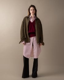 Olive green wool-blend overshirt with a relaxed, oversized fit. Features a collared neckline and button closure. Pair with the matching striped dress for a coordinated look.