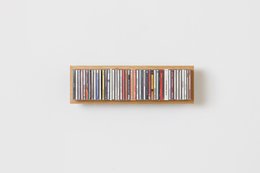Rectangular wall-mounted shelves in natural wood, designed to hold CDs or other media. Available in three different sizes to accommodate varying storage needs.