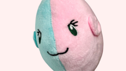 Soft, plush moon fish toy in a calming teal color. Features a rounded, whimsical shape and simple design.