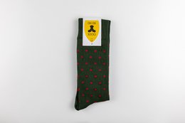 Green socks with red polka dots pattern. Made of high-quality material for comfort and durability.