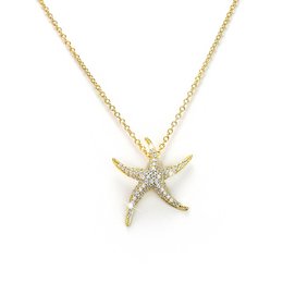 Elegant gold-tone starfish necklace with sparkling crystal accents, perfect for adding a touch of coastal charm to any outfit.