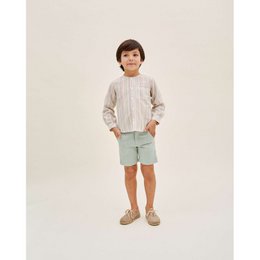  Boy's striped shirt with pocket in sizes 3 years to 12 years. Beige shirt with vertical stripes and a chest pocket.