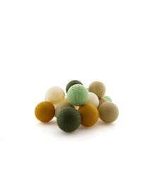 Outdoor string lights with colorful lanterns hanging from trees, creating a cozy and festive atmosphere for an outdoor picnic or gathering.