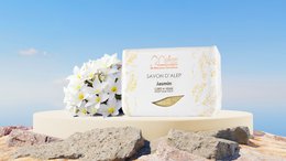 Jasmine scented Aleppo soap, handmade with natural ingredients, rectangular shape, white color with floral design.