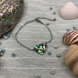 Abalone shell bracelet with a unique, handmade ocean-inspired design. Features a vibrant, iridescent shell pendant on a delicate metal chain.