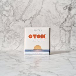 Handcrafted soap bar with orange, lemon, and rosemary scents in a minimalist packaging design.