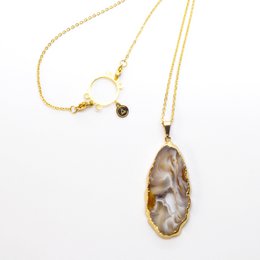 Icy brown and gold geode pendant necklace with a unique natural stone shape.