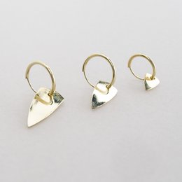 Statement earrings in sterling silver, 24k gold plated, and 14k gold in small, medium, and large sizes. Featuring a triangular shape with a polished finish.