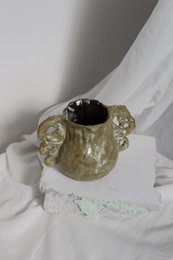 A handmade, matte gray vase with a simple, cylindrical shape.