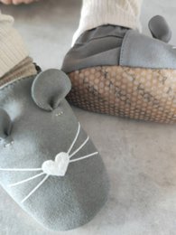  Gray mouse-shaped baby shoes with a textured sole and padded design for comfort and grip.