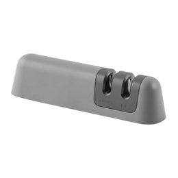  A two-phase knife sharpener with a gray, rectangular design. The sharpener has two sharpening slots and a non-slip base for stability during use.