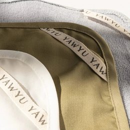 Upcycled cloth in white, blue, and olive green colors. Made from sustainable materials.